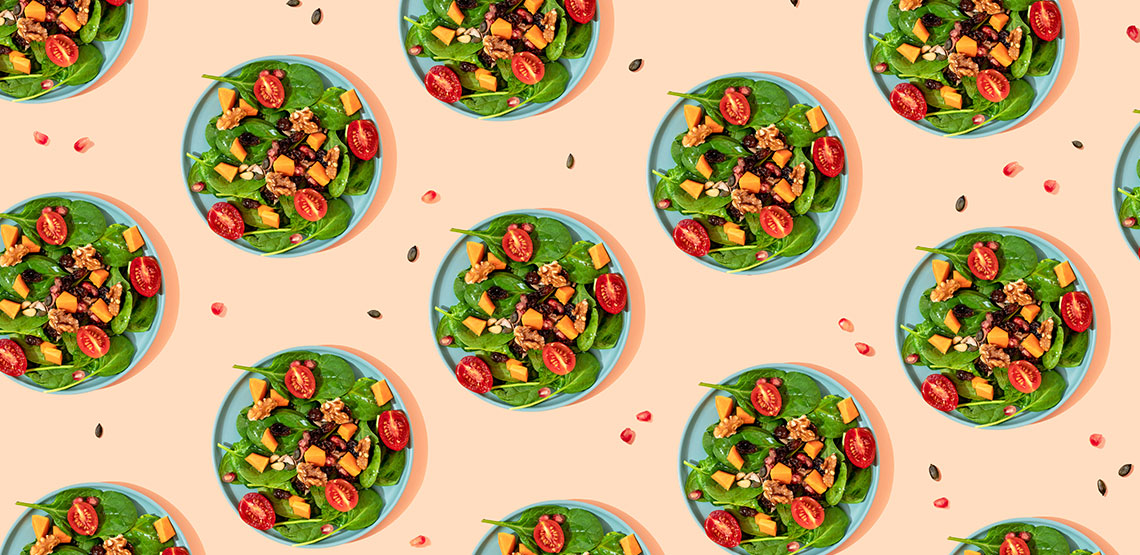 An illustration of bowls of salad on a pink background